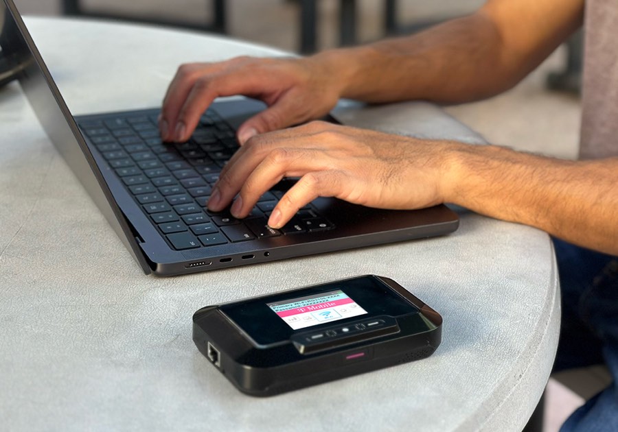 JEXtream RG3100 mobile hotspot connected to a laptop in a work setting
