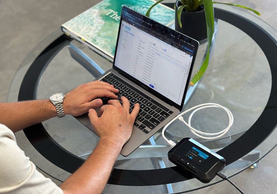 RG3102N mobile hotspot connected to a laptop in a work setting